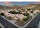 A birds eye view of a desert community at sunset featuring neutral colored homes with tile roofs and majestic mountain views at 14823 S 13Th Pl, Phoenix, AZ 85048