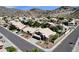 A birds eye view of a desert community featuring neutral colored homes with tile roofs, mature desert landscaping, and mountain views at 14823 S 13Th Pl, Phoenix, AZ 85048
