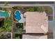 A private backyard featuring a sparkling pool, waterfall feature, lush landscaping, artificial turf, and space for outdoor dining at 14823 S 13Th Pl, Phoenix, AZ 85048
