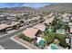 Aerial view of the property, highlighting the pool, landscaping, and surrounding neighborhood with mountain views at 14823 S 13Th Pl, Phoenix, AZ 85048