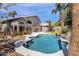 Resort style backyard featuring a sparkling pool, lush landscaping, and a spacious patio for outdoor enjoyment at 14823 S 13Th Pl, Phoenix, AZ 85048