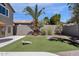 Well maintained backyard featuring lush green turf, tasteful landscaping, and plenty of room for outdoor activities at 14823 S 13Th Pl, Phoenix, AZ 85048