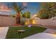 Inviting backyard featuring artificial turf, a palm tree, and a charming bean bag toss game area at 14823 S 13Th Pl, Phoenix, AZ 85048