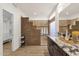Modern bathroom boasts a step-up shower, floating vanity, and sleek fixtures at 14823 S 13Th Pl, Phoenix, AZ 85048