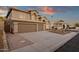 Inviting two-story home boasts desert landscaping, a three-car garage and arched entryway at 14823 S 13Th Pl, Phoenix, AZ 85048