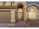 Charming home features arched entryway, manicured desert landscaping, and three-car garage at 14823 S 13Th Pl, Phoenix, AZ 85048