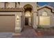 Charming home features arched entryway, manicured desert landscaping, and three-car garage at 14823 S 13Th Pl, Phoenix, AZ 85048