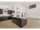 Spacious kitchen with island including wine cooler, granite countertops, and stainless steel appliances at 14823 S 13Th Pl, Phoenix, AZ 85048
