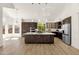 Open-concept kitchen with an island, granite countertops, stainless steel appliances, and wood floors at 14823 S 13Th Pl, Phoenix, AZ 85048