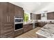 Modern kitchen with stainless steel appliances, granite countertops, undermount sink and custom cabinetry at 14823 S 13Th Pl, Phoenix, AZ 85048