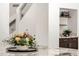 Granite countertops with a beautiful flower display, shelving, and modern design create an inviting culinary space at 14823 S 13Th Pl, Phoenix, AZ 85048