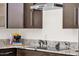 Modern kitchen with stainless steel range hood over cooktop and granite countertop at 14823 S 13Th Pl, Phoenix, AZ 85048