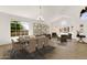 Bright and airy living room with dining area, modern lighting, wood floors and large windows at 14823 S 13Th Pl, Phoenix, AZ 85048