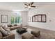Nicely decorated living room with neutral furniture, vaulted ceiling, and decorative art at 14823 S 13Th Pl, Phoenix, AZ 85048