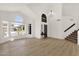 Inviting living room with wood floors, staircase, and large windows providing ample sunlight at 14823 S 13Th Pl, Phoenix, AZ 85048