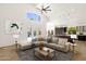 Living room featuring comfortable sectional sofa, bright room, and kitchen at 14823 S 13Th Pl, Phoenix, AZ 85048