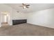 Bright living room boasts neutral carpet, ceiling fan, and built-in cabinets at 14823 S 13Th Pl, Phoenix, AZ 85048