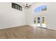 Bright, open living room with soaring ceilings and a ceiling fan and direct access to outdoor living at 14823 S 13Th Pl, Phoenix, AZ 85048
