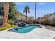 Sparkling pool area with rock waterfall feature, well-manicured landscaping, and ample space for relaxation at 14823 S 13Th Pl, Phoenix, AZ 85048
