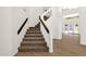 Close up of the staircase features neutral carpet, dark wood railing, and glass accents at 14823 S 13Th Pl, Phoenix, AZ 85048