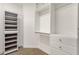 Walk-in closet showcasing white shelves, a hanging rod, and three storage drawers at 14823 S 13Th Pl, Phoenix, AZ 85048