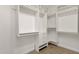 Well-organized walk-in closet with white shelving, drawers, and ample storage space at 14823 S 13Th Pl, Phoenix, AZ 85048