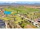 Aerial view of a lush golf course, ponds, landscaping, and green common areas within a Primary planned community at 17332 W Wildwood St, Surprise, AZ 85388
