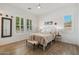 Bright bedroom with wood-look flooring, large windows with shutters, and cozy, neutral decor at 17332 W Wildwood St, Surprise, AZ 85388