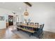 Bright dining room featuring a rustic wood table, bench seating, and stylish decor at 17332 W Wildwood St, Surprise, AZ 85388