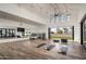 Bright exercise room with mirrored wall, high ceilings, and outdoor access at 17332 W Wildwood St, Surprise, AZ 85388