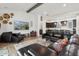 Spacious living room boasting a comfortable leather sofa, a beamed ceiling, and an open layout at 17332 W Wildwood St, Surprise, AZ 85388