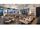 View of restaurant seating with table settings, dining chairs, modern lighting fixtures, and picturesque outdoor view at 17332 W Wildwood St, Surprise, AZ 85388