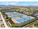 Aerial view showcasing tennis courts, providing ample opportunities for sports and recreation with mountain views at 17332 W Wildwood St, Surprise, AZ 85388