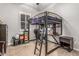 Unique bedroom featuring a loft bed with built-in desk and shelving for study and storage at 19571 E Strawberry Dr, Queen Creek, AZ 85142
