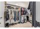 Walk-in closet with built in shelving and hanging racks for optimal storage space at 19571 E Strawberry Dr, Queen Creek, AZ 85142