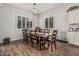 Elegant dining room with wood floors and a modern chandelier, perfect for Gathering gatherings at 19571 E Strawberry Dr, Queen Creek, AZ 85142