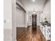 Inviting foyer with hardwood floors, arched doorways, white trim and a modern light fixture at 19571 E Strawberry Dr, Queen Creek, AZ 85142