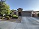 Charming single-story home boasts manicured landscaping and a spacious driveway leading to a two-car garage at 19571 E Strawberry Dr, Queen Creek, AZ 85142