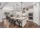Bright, open kitchen featuring granite countertops, stainless steel appliances, and breakfast bar seating at 19571 E Strawberry Dr, Queen Creek, AZ 85142