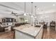 Spacious kitchen island with seating, overlooking a cozy living area and dining space at 19571 E Strawberry Dr, Queen Creek, AZ 85142