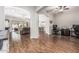 Open-concept living room with hardwood floors, neutral walls, ceiling fan, and lots of natural light at 19571 E Strawberry Dr, Queen Creek, AZ 85142