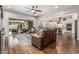 Spacious living room with hardwood floors, open floor plan, and sliding door access to the backyard at 19571 E Strawberry Dr, Queen Creek, AZ 85142