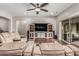Comfortable living room with a ceiling fan, a media center, and a sliding door leading to the backyard at 19571 E Strawberry Dr, Queen Creek, AZ 85142