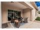 Covered patio features an outdoor table and chairs with an outdoor rug at 19571 E Strawberry Dr, Queen Creek, AZ 85142