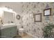 Charming powder room featuring designer wallpaper, stylish vanity, and decorative mirrors for a modern, sophisticated look at 20563 W White Rock Rd, Buckeye, AZ 85396