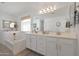 Bright bathroom with a bathtub, double sink vanity and large mirror at 20563 W White Rock Rd, Buckeye, AZ 85396