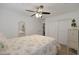 Bright bedroom features floral bedding and a ceiling fan at 20563 W White Rock Rd, Buckeye, AZ 85396