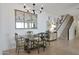 This dining room features a chandelier, tile floors, and stylish furniture at 20563 W White Rock Rd, Buckeye, AZ 85396