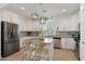 Modern kitchen featuring white cabinets, stainless steel appliances, and a granite island at 20563 W White Rock Rd, Buckeye, AZ 85396