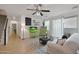 Bright living room featuring a ceiling fan, neutral furniture, and tile flooring at 20563 W White Rock Rd, Buckeye, AZ 85396